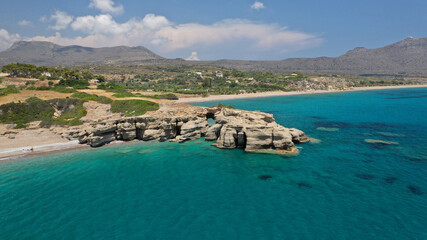 Obraz premium Aerial drone photo not so famous Limnitsa beach with strange rock formations near small picturesque village of Avlemonas, Kythira island, Ionian, Greece
