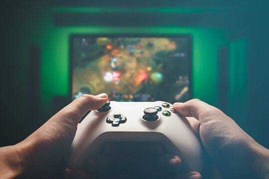 Video gaming console. Man playing RPG strategy game
