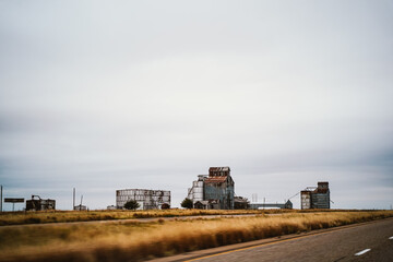 Roadside agricultural buildings in Rural America against overcast sky