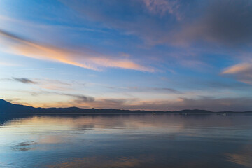 Colorful clouds reflecting in water over Lake Tahoe California after sunset