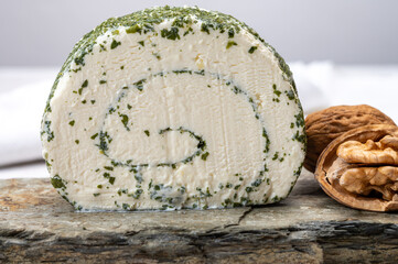 Cheese collection, fresh white soft goat French cheese roll with aromatic herbs and chives