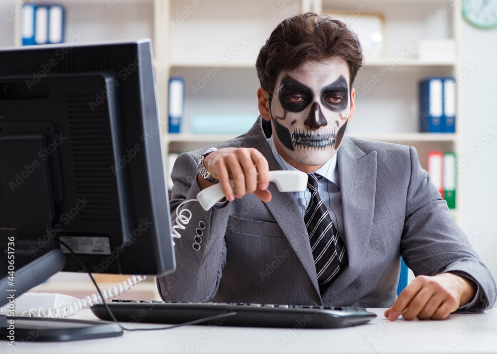 Wall mural Businessmsn with scary face mask working in office - Wall murals