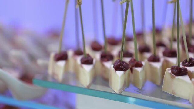 buffet table with snacks on skewers