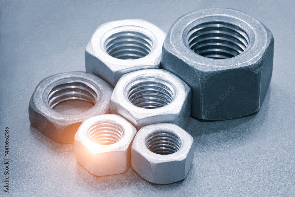 Poster metal nuts in a row. chromed screw nuts. tools for work.