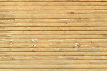 The texture of the wall made of horizontal wooden slats, background.