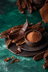 Carob pods, powder and molasses or syrup