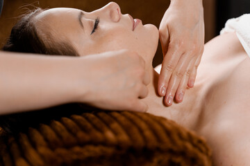 Neck and face massage in the spa. Beauty treatments for an attractive female model. Relaxation,