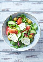 Summer Salad with Cream Cheese, green Olives, Tomatoes and fresh Basil. Top view. 