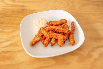 Chicken fingers appetizer with mayonnaise sauce to dip