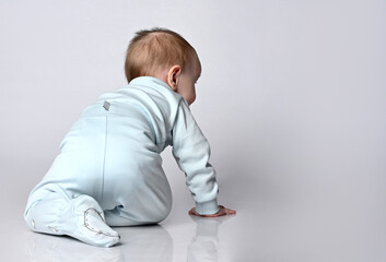 Children's baby baby crawling back from the rear view on a white background