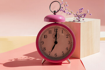 pink alarm clock, sunny morning, early wake up concept.