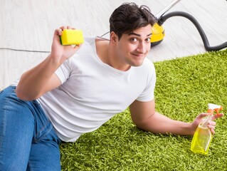 Young husband man cleaning floor at home