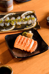 Delicious Sushi Menu Food Sashimi Salmon Tuna Shrimp Hashi Holds Gourmet Plate Restaurant Wooden Table