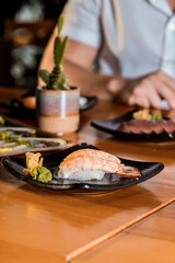 Delicious Sushi Menu Food Sashimi Salmon Tuna Shrimp Hashi Holds Gourmet Plate Restaurant Wooden Table
