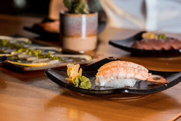 Delicious Sushi Menu Food Sashimi Salmon Tuna Shrimp Hashi Holds Gourmet Plate Restaurant Wooden Table