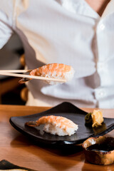 Delicious Sushi Menu Food Sashimi Salmon Tuna Shrimp Hashi Holds Gourmet Plate Restaurant Wooden Table