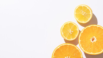 Halves of orange, lemon on white background. Top view. Composition of juicy citruses with place for text. Concept of diet, health, taste, food. Isolated. Bright light. 9x16. Copy space