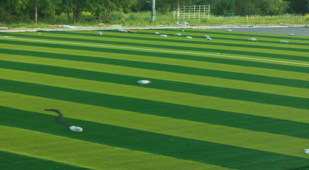 Close-up. Replacing the football surface with a new artificial turf.