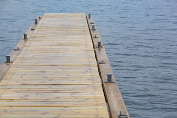 Fototapeta premium Wooden pier and grass on lake shore on sunny summer day