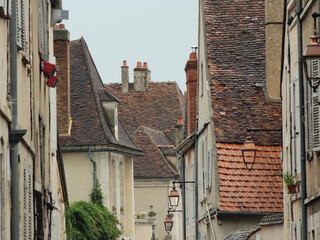 Street view of medieval French city of Auxerre in Yonne, Burgundy. Romantic atmosphere of historic France urban heart while France opens its borders for tourists after Covid 19 coronavirus pandemic.