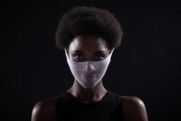 Portrait of african american dark skin woman fashion model quarantine medical fishnet knitting face mask coarse mesh net. Covid-19 coronavirus protection unsafe dangerous concept.