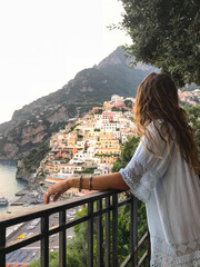 Italy, Amalfi Coast, Amalfi, Sorrento. Positano view of colorful houses. Girl looking the horizon	
