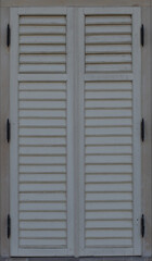 Wooden shutters and a window with closed shutters. Bright old fashioned vintage.