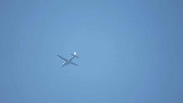 Transall aircraft flying in a hazy blue sky