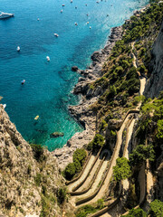 Italy, Amalfi Coast, Capri. Aerial drone shot view of faraglioni limestone crags in summer time in Tyrrhenian sea off	
