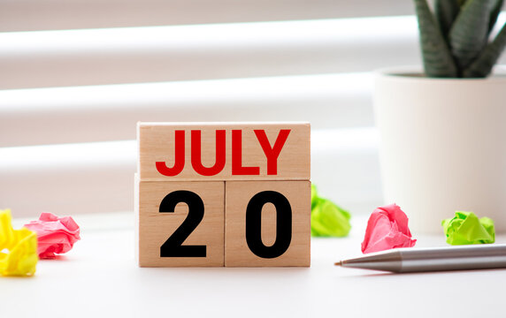 July 20, Cover Design With Number Cube On A White Background And Granite Table.