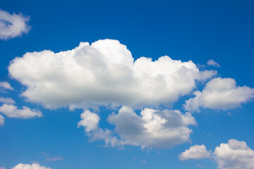 Naklejka na ściany i meble Blue sky with white and gray clouds. Bright sunny cloudscape 