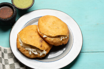 Chicharron gorditas with cheese on turquoise background. Mexican food