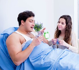 Wife visiting ill husband in the hospital room