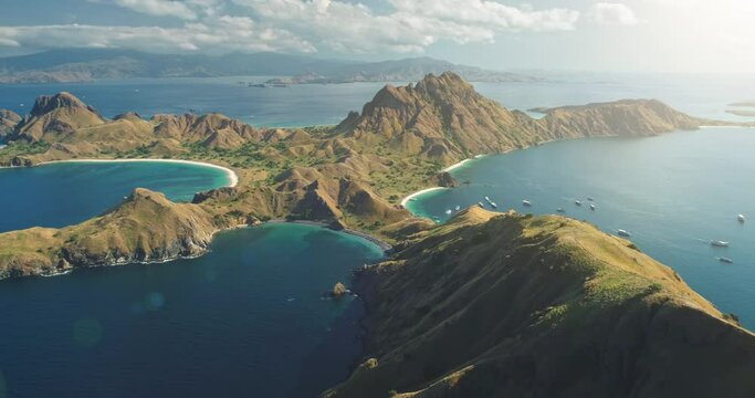 Padar Komodo Island Aerial Panorama. Travel destination. Nature background. Beautiful wild landscape. Exotic summer holiday. Travel, outdoor tourism, vacation. Cinematic drone flight Flores, Indonesia
