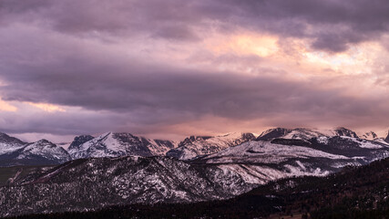 Fototapeta na wymiar Peaceful Winter Sunset at Rocky Mountain National Park with snow-capped mountains