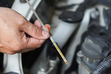convertible car mechanic check engine oil mechanic's side view Also check the oil level in the car. Special tool, male hand, with a durable automotive engine oil dipstick. for safety for travel