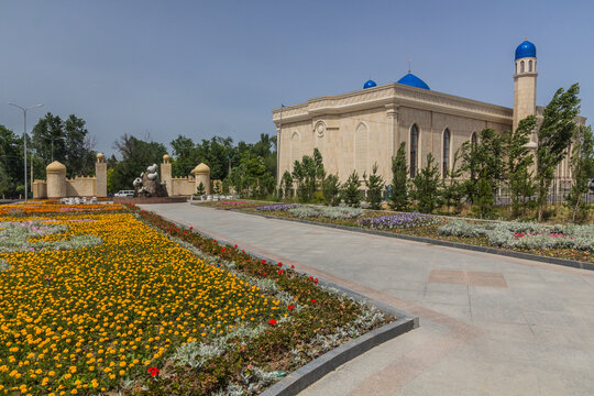 Park with flower beds and Mosque Keneskhan Haji in Taraz, Kazakhstan
