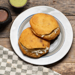 Chicharron gorditas with cheese on wooden background. Mexican food