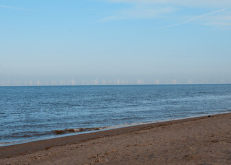 Sand beach, sea and cloudy blue sky in England in sunny day