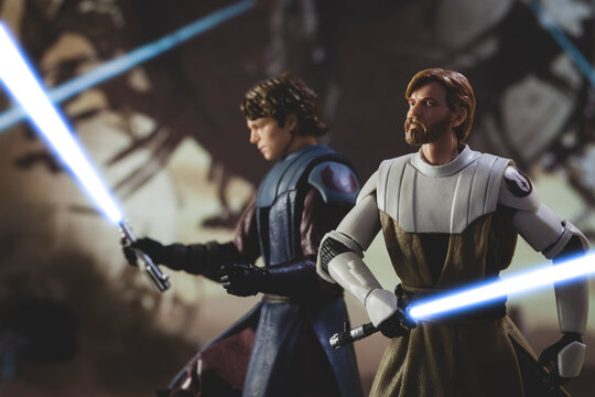 NEW YORK USA, JUNE 23 2021: Star Wars The Clone Wars Jedi General Obi Wan Kenobi and Anakin Skywalker with lightsabers in battle - Hasbro action figure