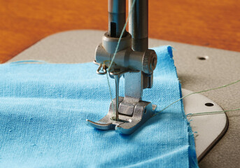 Element of sewing-machine with a piece of textile, closeup, macro