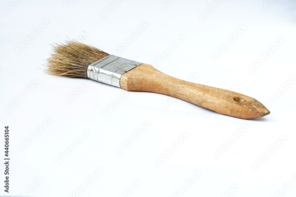 Wall mural old brush with a wooden handle isolated on a white background