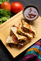 Grill steak mulitas with fresh sauce and cheese on dark background. Mexican food
