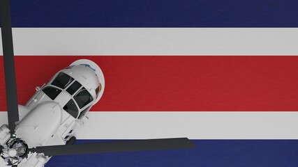 Top down view of a White Helicopter in the Bottom Left Corner and on top of the National Flag of Costa Rica