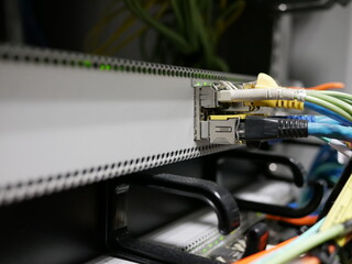 fiber optic cable network connected to internet switch servers in data center. 