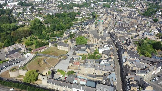 Flight over the city Guingamp and Basilica of Our Lady of Merciful on summer day. France