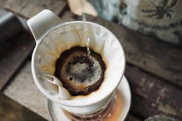 barista dripping coffee and slow coffee bar style