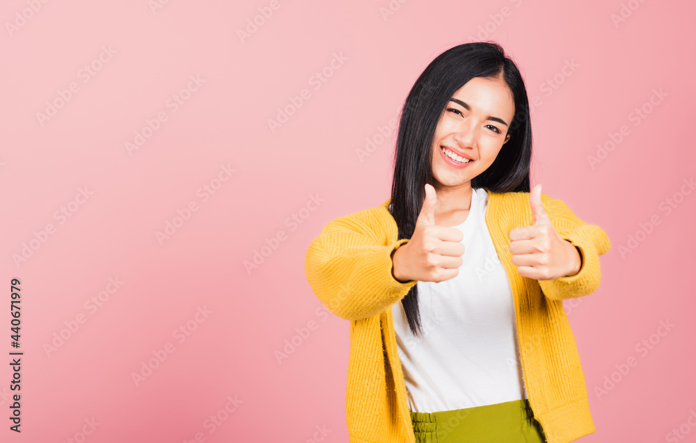 Wall mural .portrait asian beautiful young woman smile she standing made finger thumbs up, ok sign to agree stu