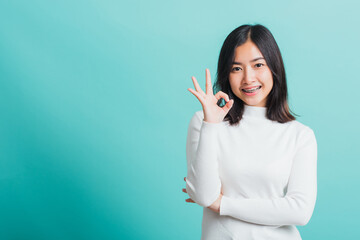 Young beautiful Asian woman smiling and showing hand the OK sign, Portrait female show finger okay...