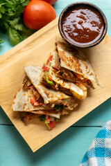 Grill steak mulitas with fresh sauce and cheese on turquoise background. Mexican food